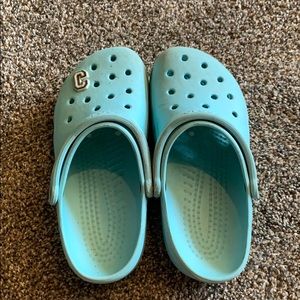 light blue crocs with c charm